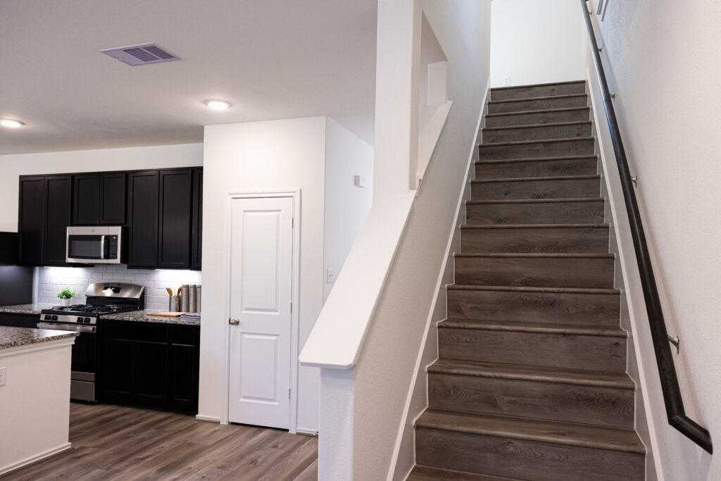 brown stairs going up to another floor within a townhome