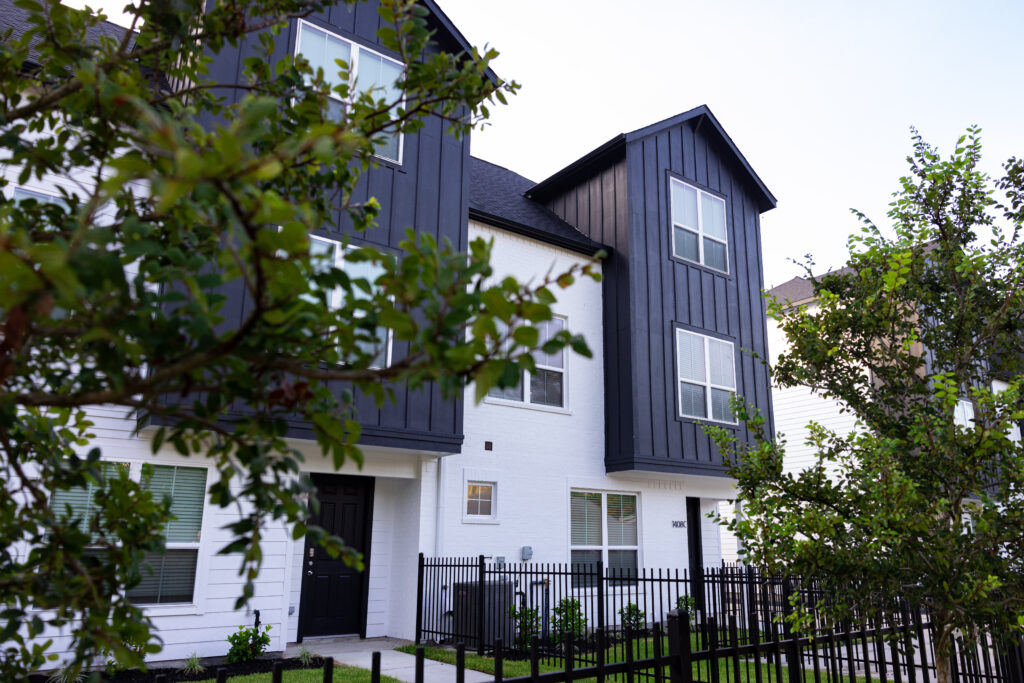 trees in front of a townhome in houston texas