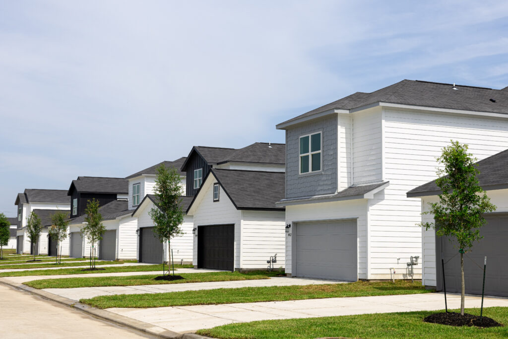 4 houses that are grey and white next to each other