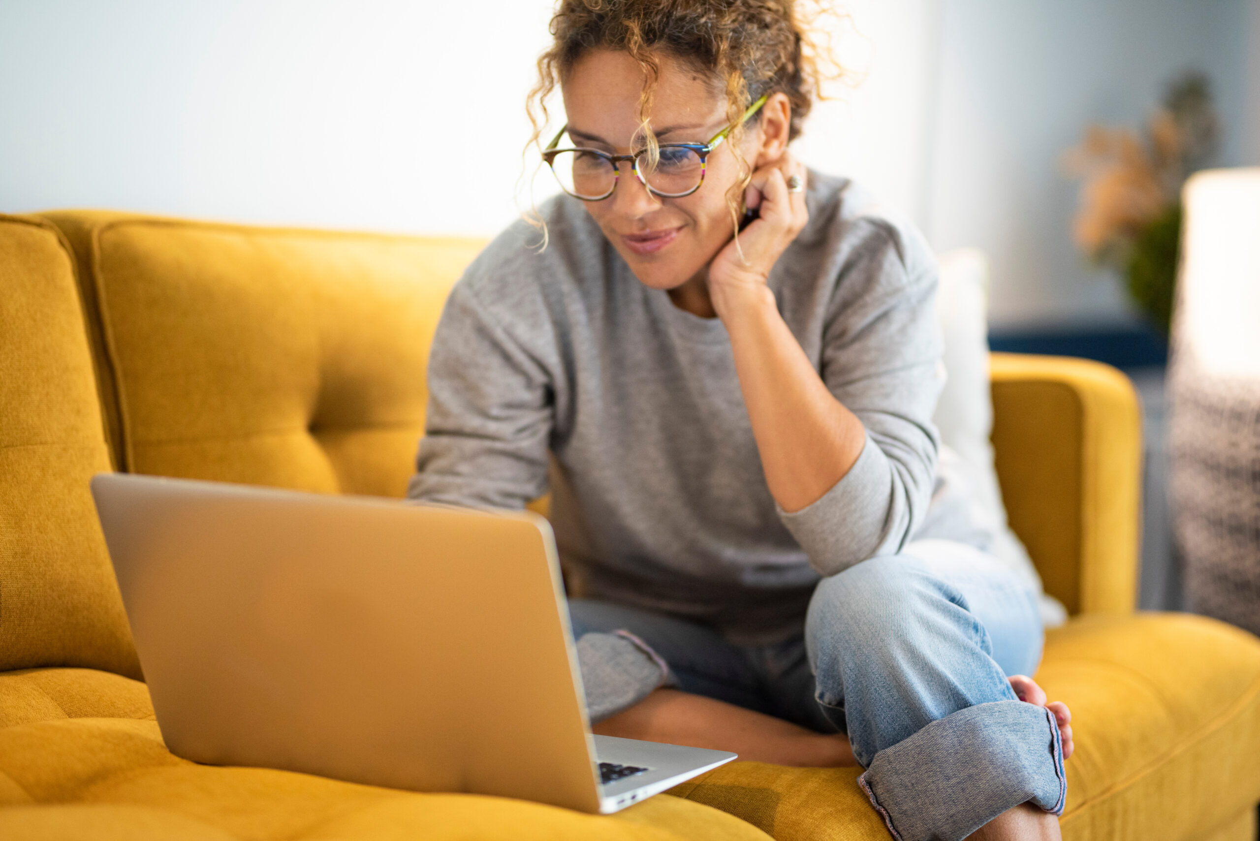 Woman Searching For Homes To Rent On Laptop