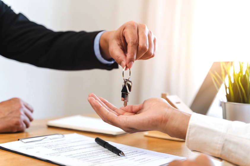 Realtor handing keys to home buyer