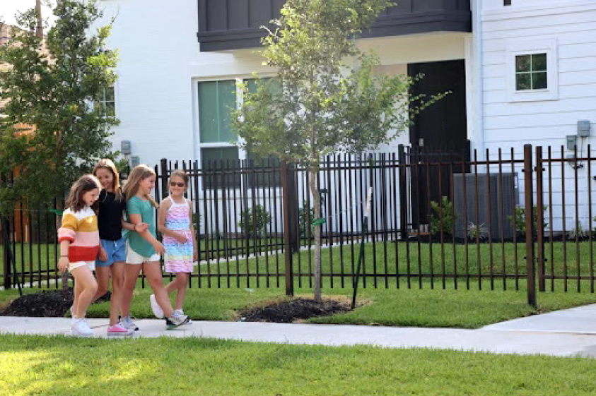 A group of kids walking in front of HomeSite home